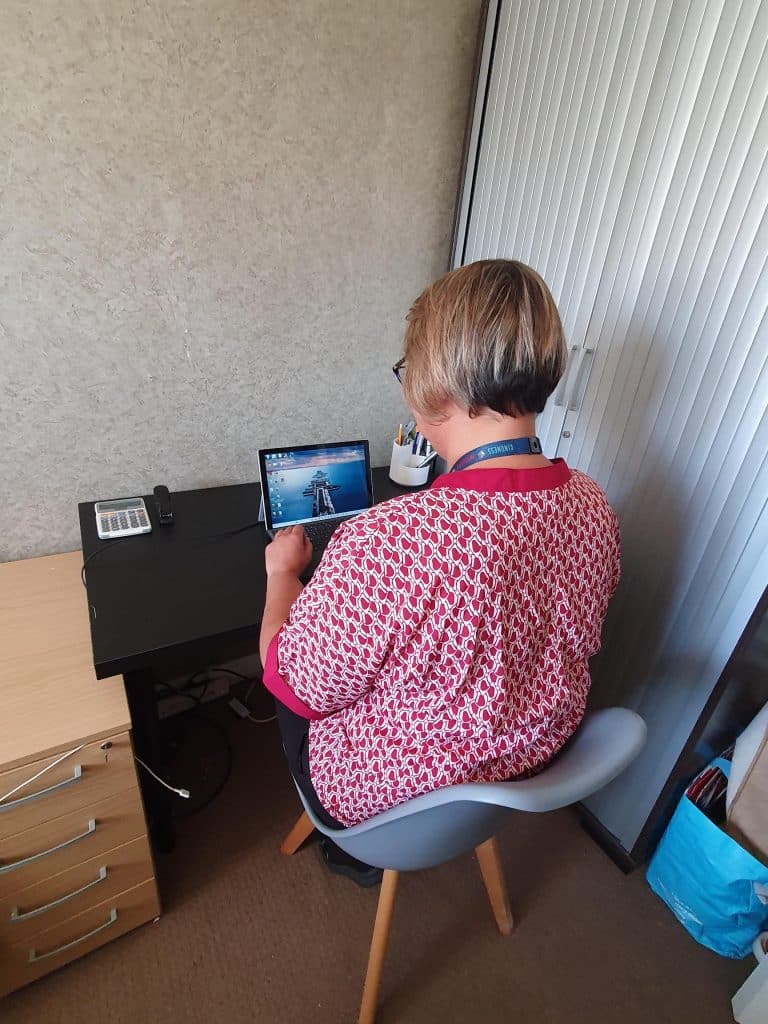 Lady sat an unergonomic desk