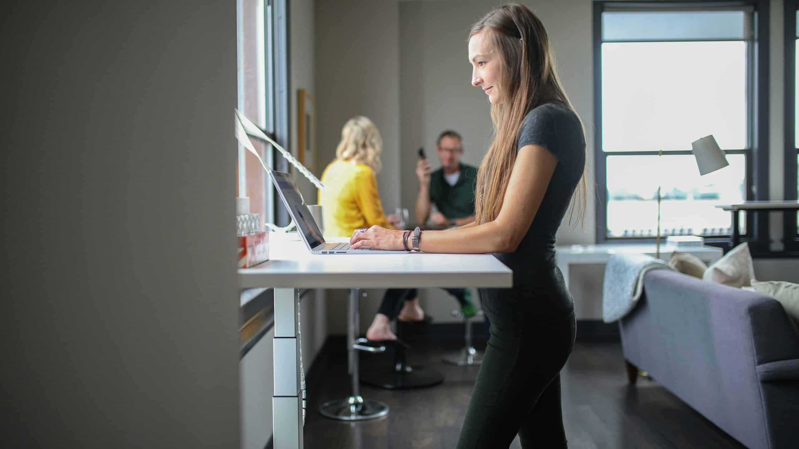 woman in black tank top and black pants sitting on chair
